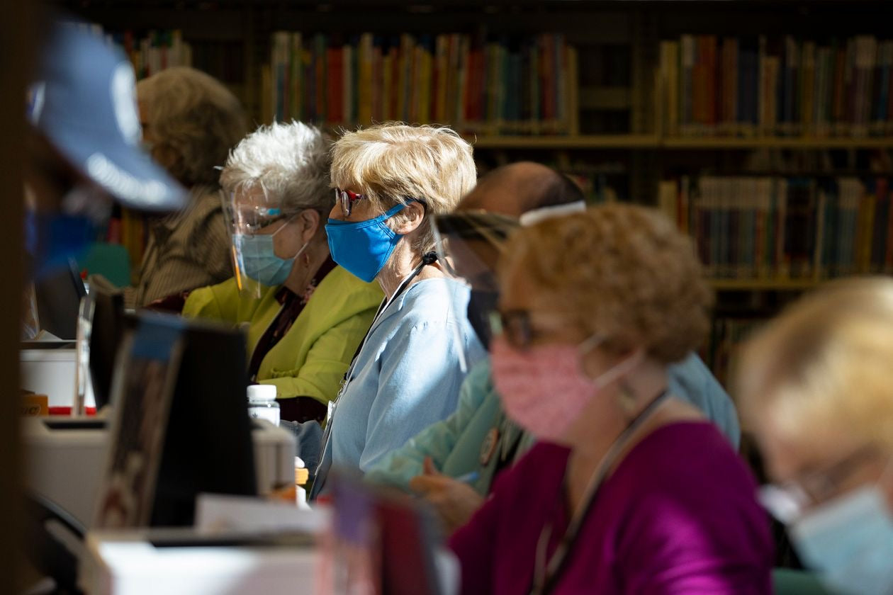 Poll Workers wear protective Equipment while assisting voters Wednesday at an early voting station in Nashville, Tenn. Photo: Brett Carlsen / Getty Images