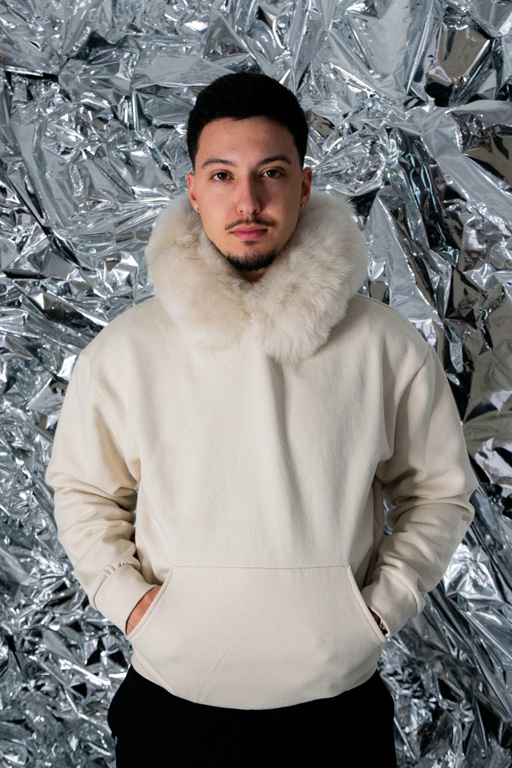 GENUINE MERINO FUR HOODIE model wearing size large showing pocket