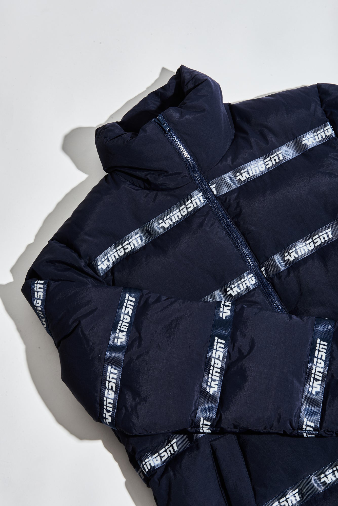 AKINGS Logo Puffer Jacket in navy, front view with full zip