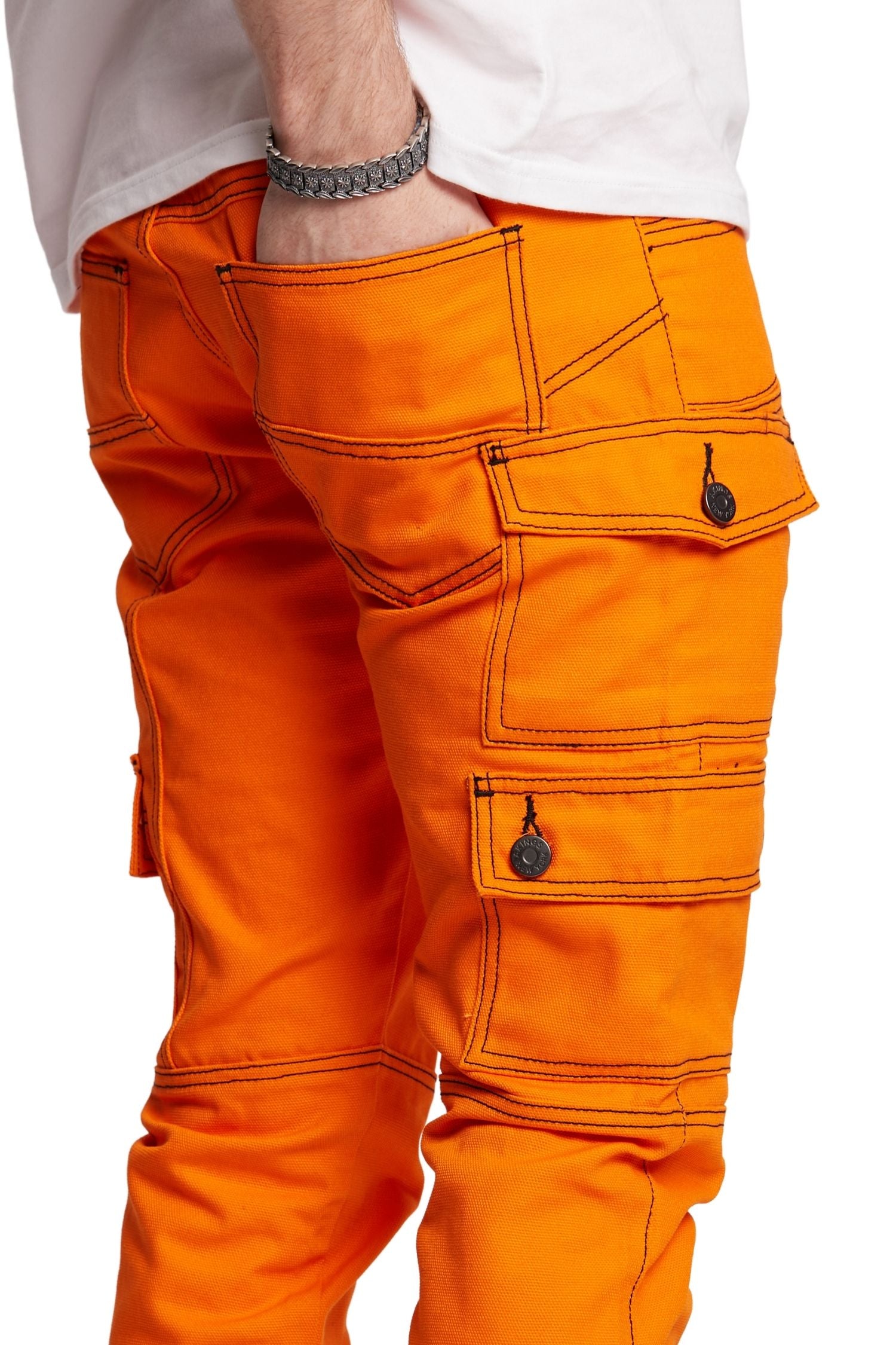 CLOSE UP VIEW OF BACK POCKET OF ORANGE KYLE SNAP CARGO PANTS