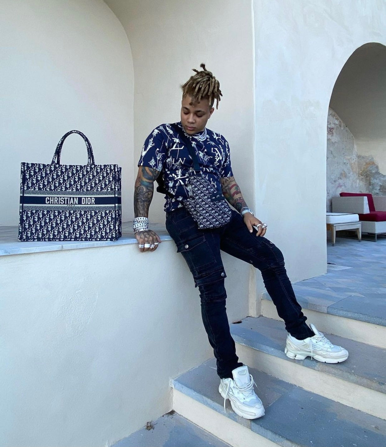 reggie mills in dior, Louis Vuitton, and akings on amalfi coast