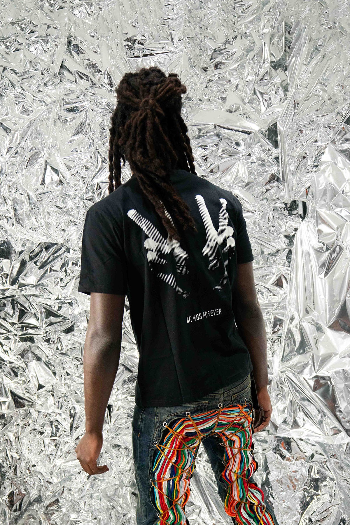 model wearing size medium of Peace T-shirt showing full back print of ‘Peace’ design

