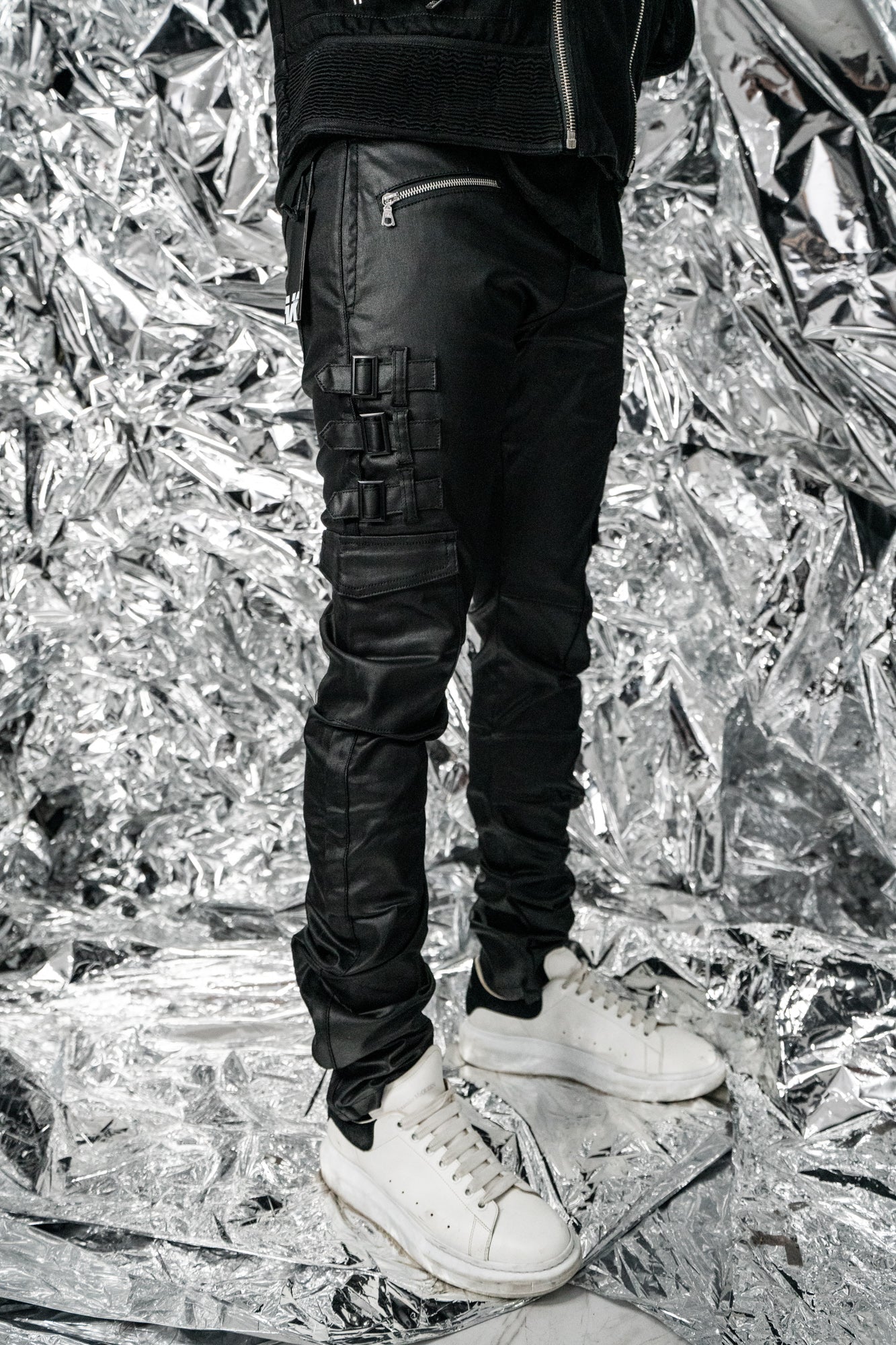 Side view of Omari Waxed Jeans showing the stack silhouette 
