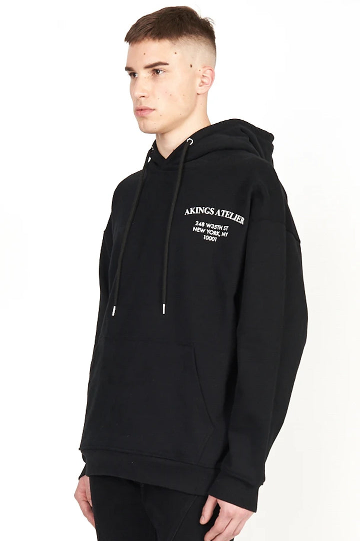 side view of chest logo and drawstring of Atelier Hoodie
