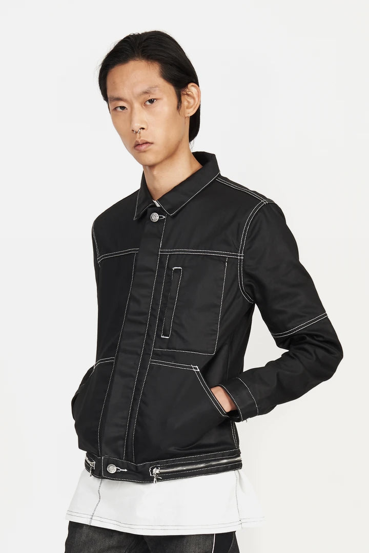 CLOSE UP PHOTO OF Side view showing waxed texture and pocket flap detail
