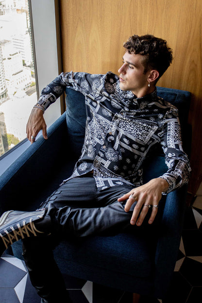 model sitting in a couch wearing a size large bandana shirt