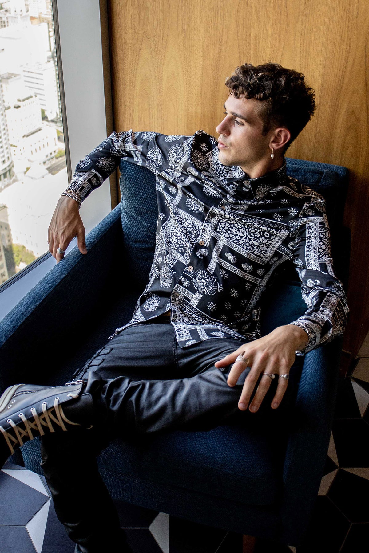 model sitting in a couch wearing a size large bandana shirt