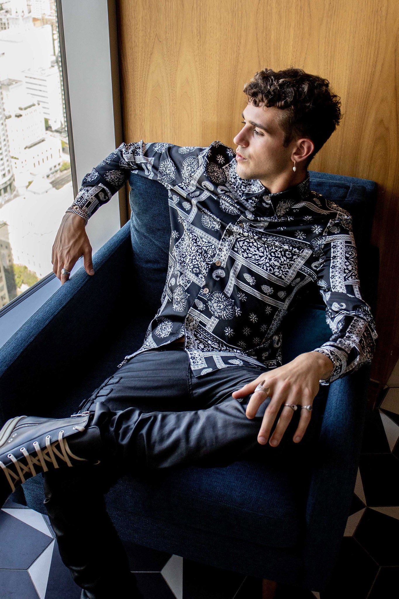 model sitting in a couch wearing a size large bandana shirt